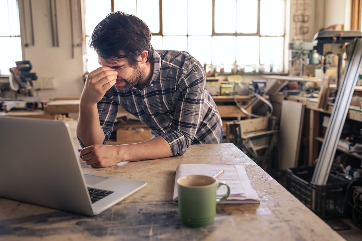 contractor-on-computer-in-workshop