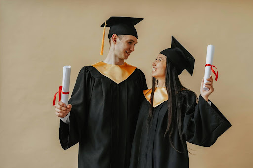 two-people-holding-diplomas