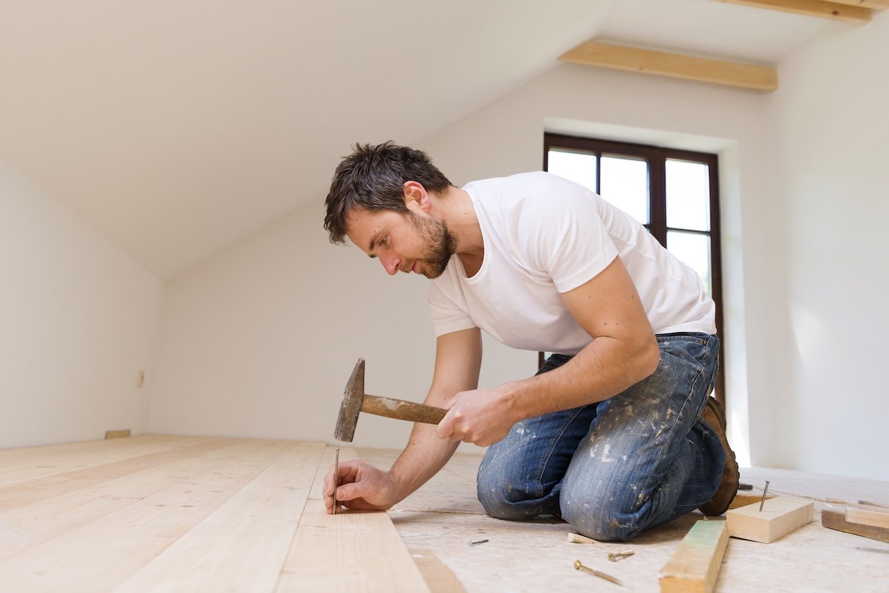 Close-up of wooden flooring planks installed in a room, showing the natural grain and finish.