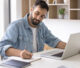 Flooring installer reviewing job schedule on computer.