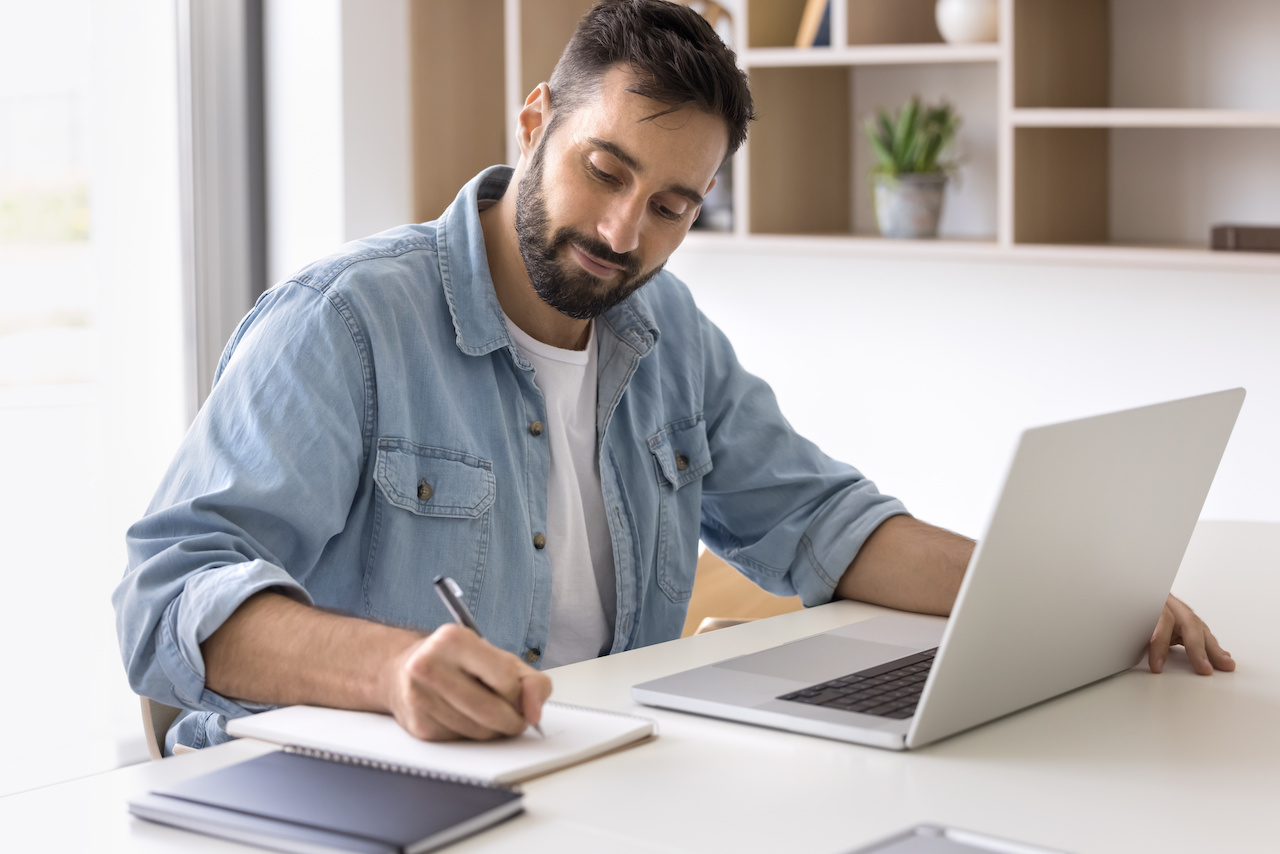 Flooring installer reviewing job schedule on computer.