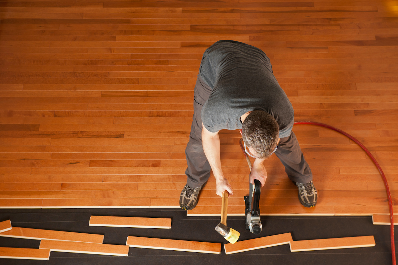 Professional installing hardwood floors.