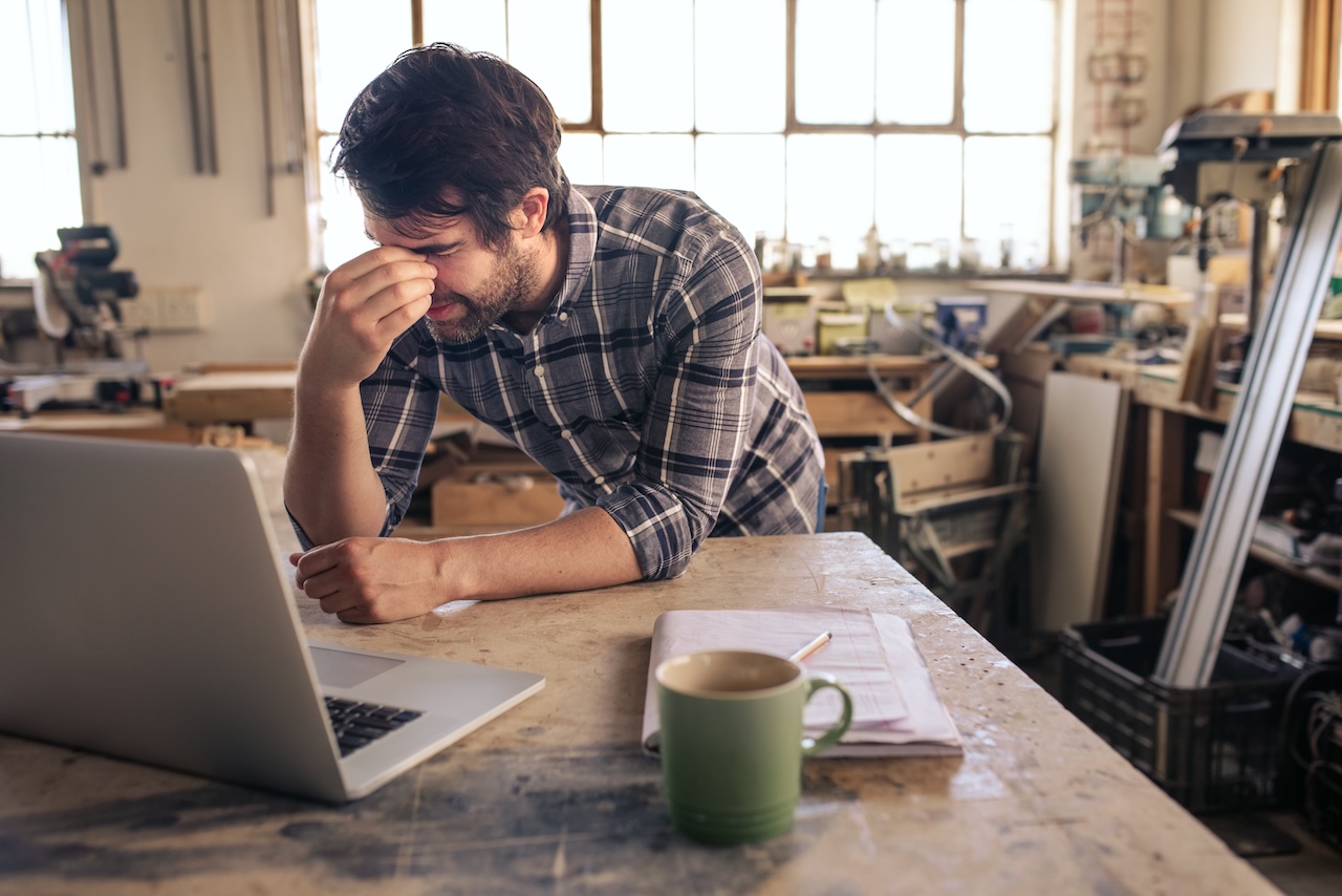 Business owner on computer in workshop