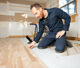 Professional flooring installer working on a kitchen remodel.