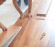 Flooring professionals installing laminate flooring