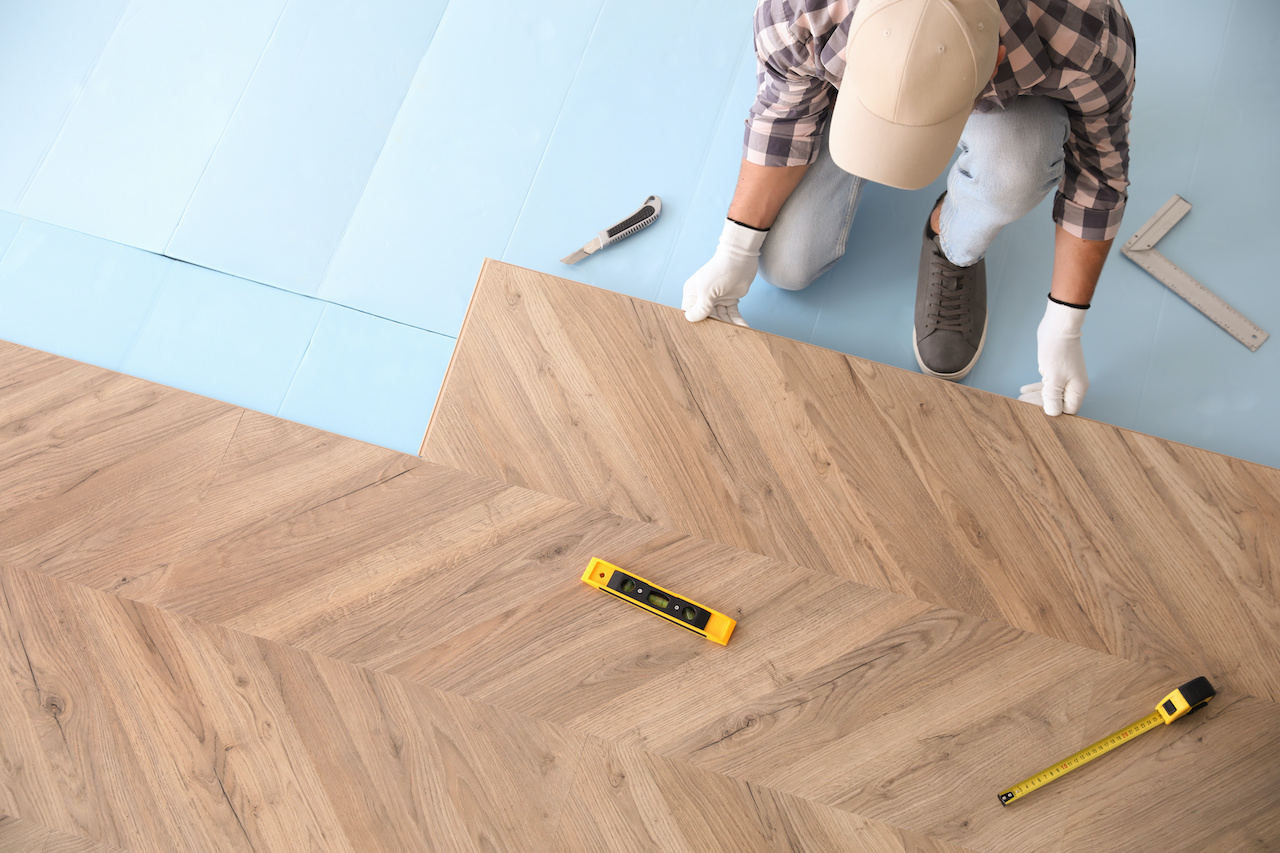 Professional flooring installation from above.