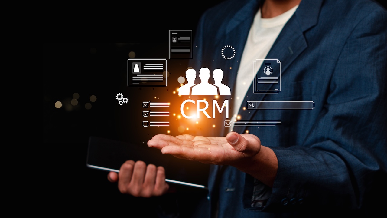 Businessman using digital customer relationship management CRM interface to manage customer data and marketing solutions.