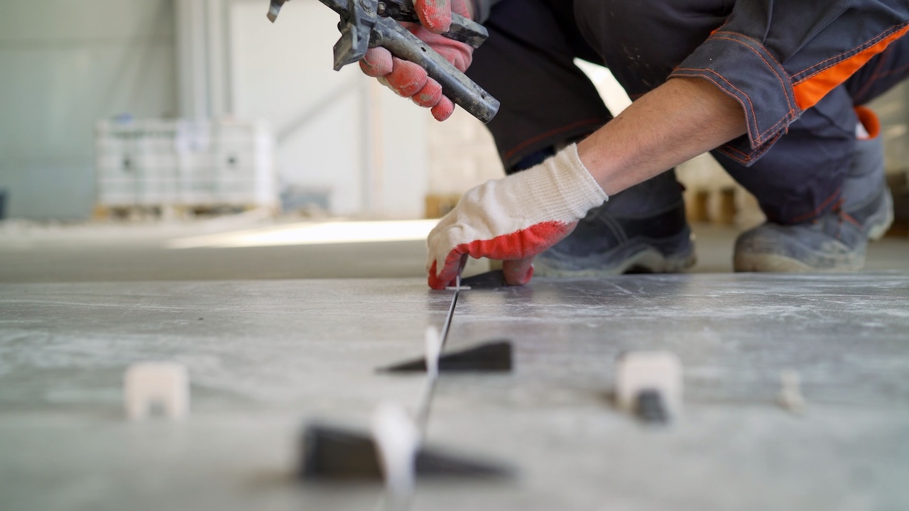 Tile installer using leveling planks.