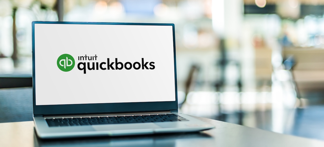 Laptop displaying QuickBooks logo on screen, illustrating accounting integration with flooring inventory software.